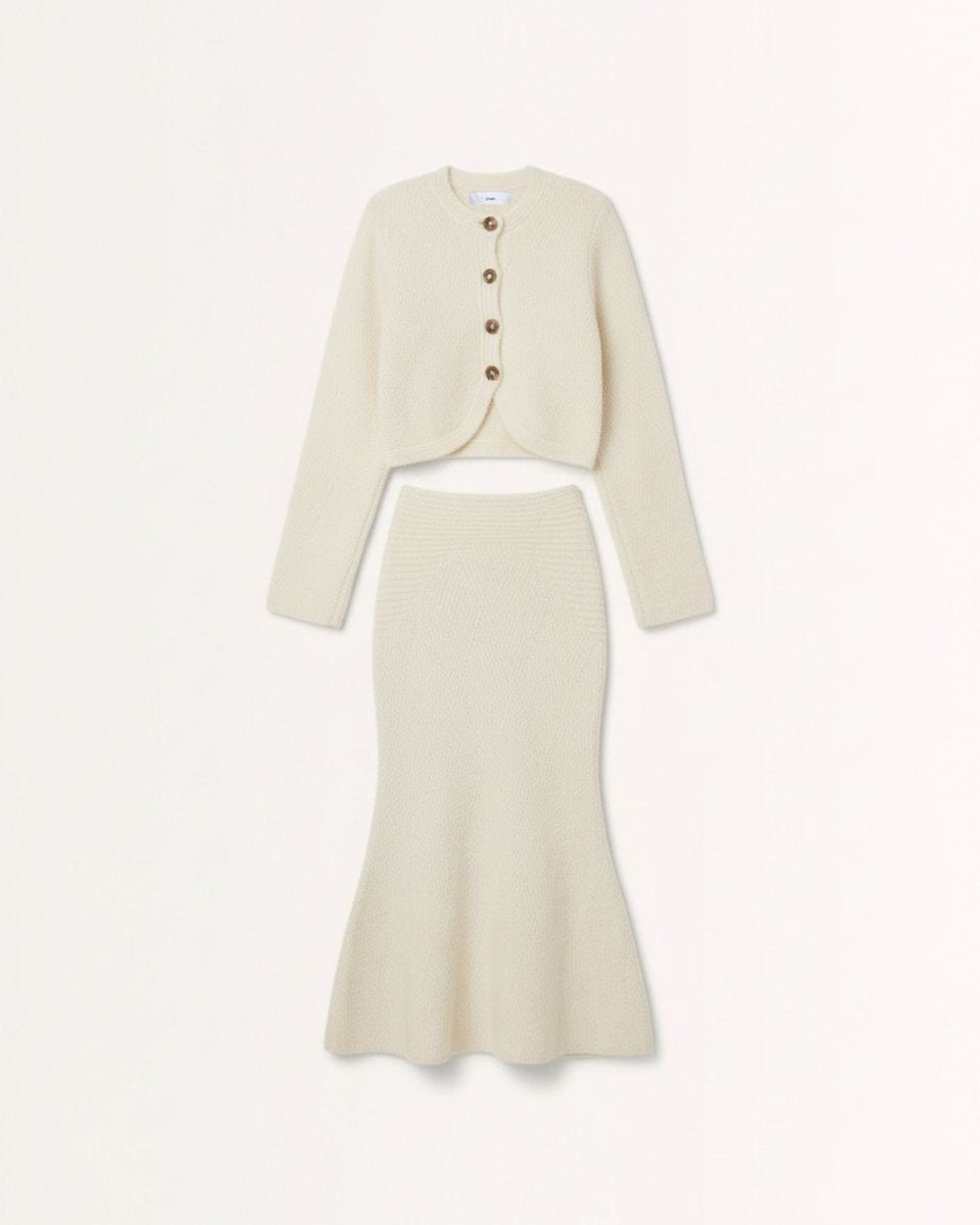 Professional woman wearing sophisticated neutral blazer and classic pieces for timeless work style
