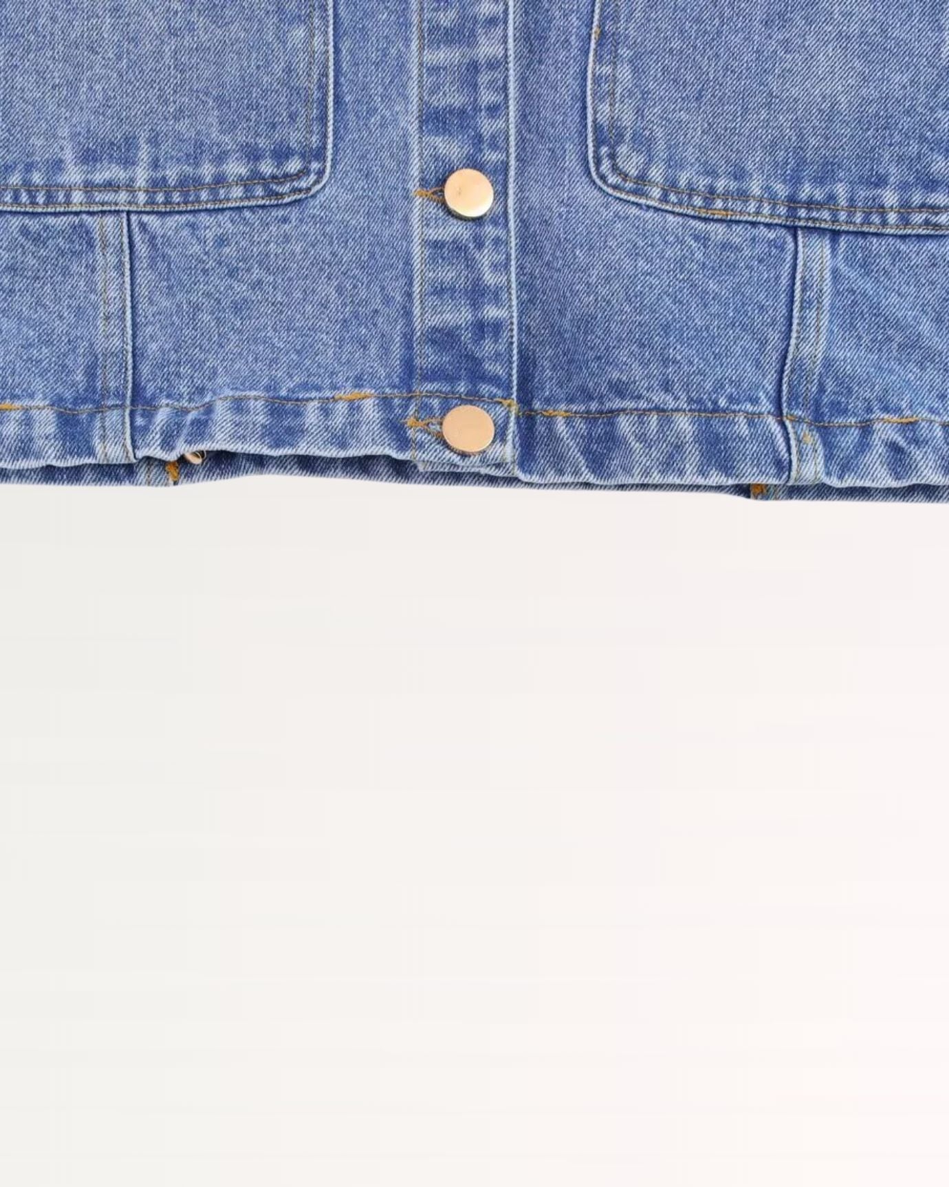 Classic blue denim shirt with button front, collar, and cuff closures for versatile wear