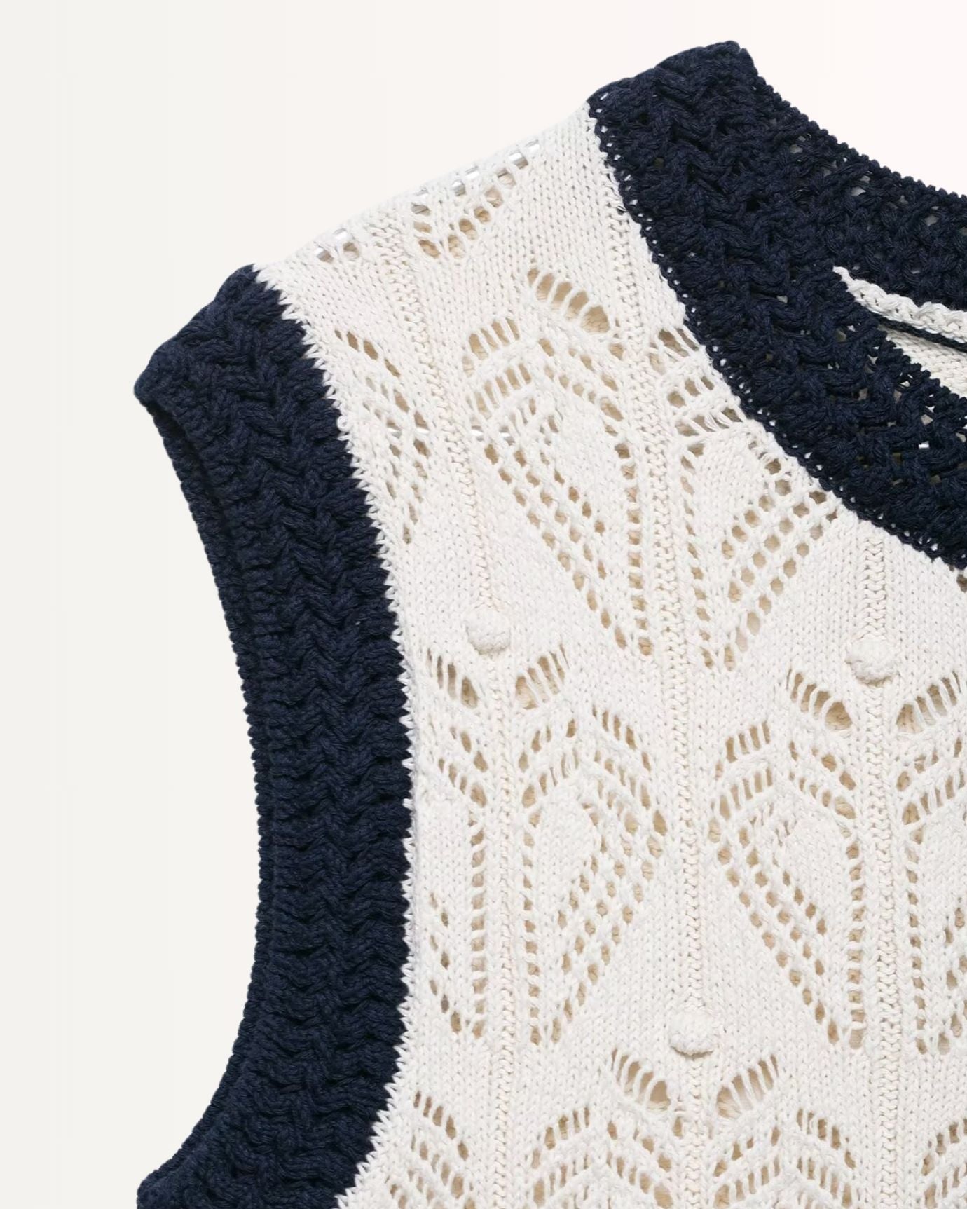 Old Money inspired vest with fine jacquard texture and mesh side panels for ventilation