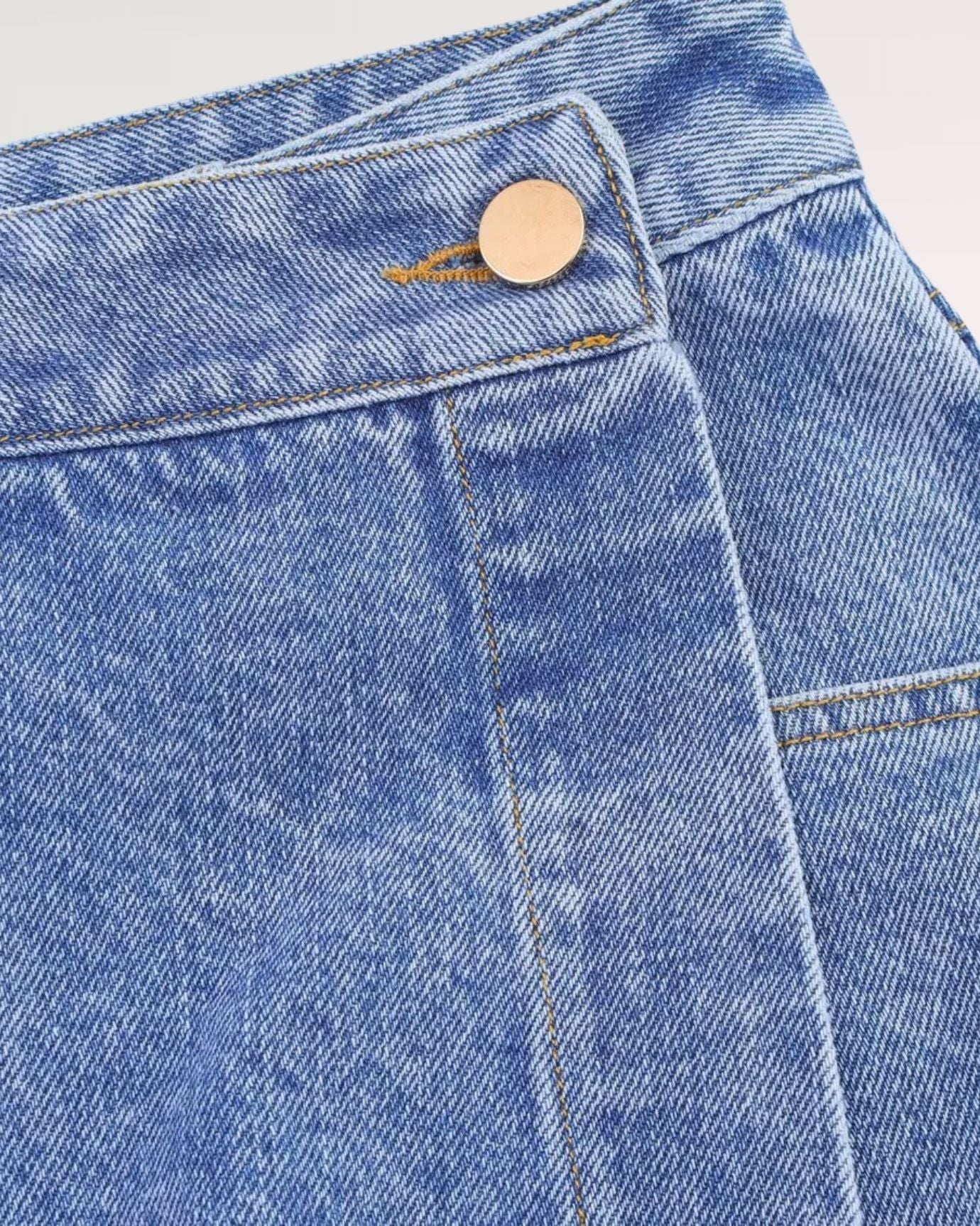 Front view of denim skirt showing structured waistband and clean stitching