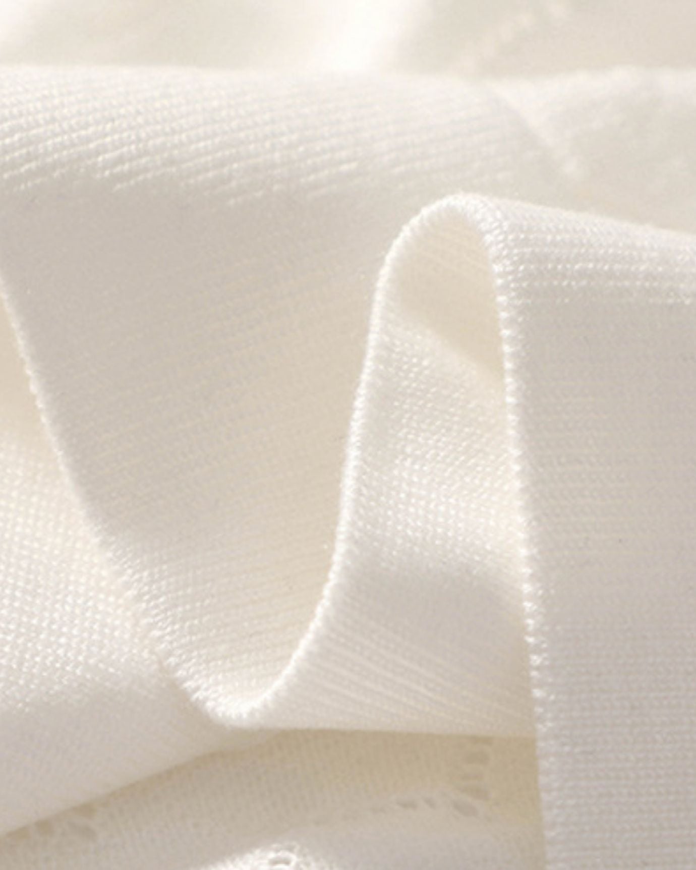 Stitching and smooth knit pattern detail on White knitted polo