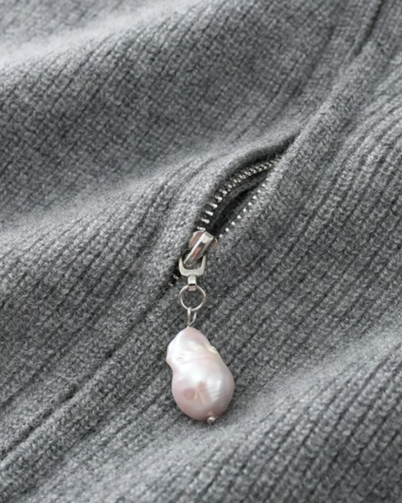 Detail of baroque pearls on soft cashmere fabric