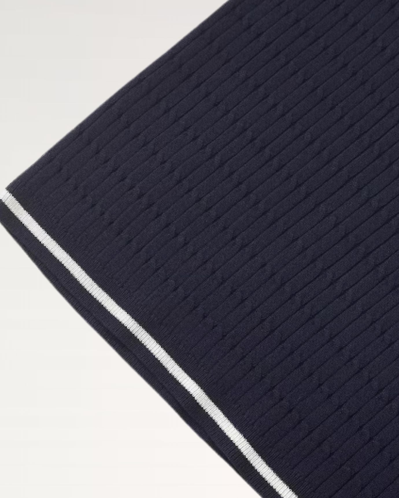 Navy short-sleeve cotton polo featuring contrast stitching that highlights the collar detail