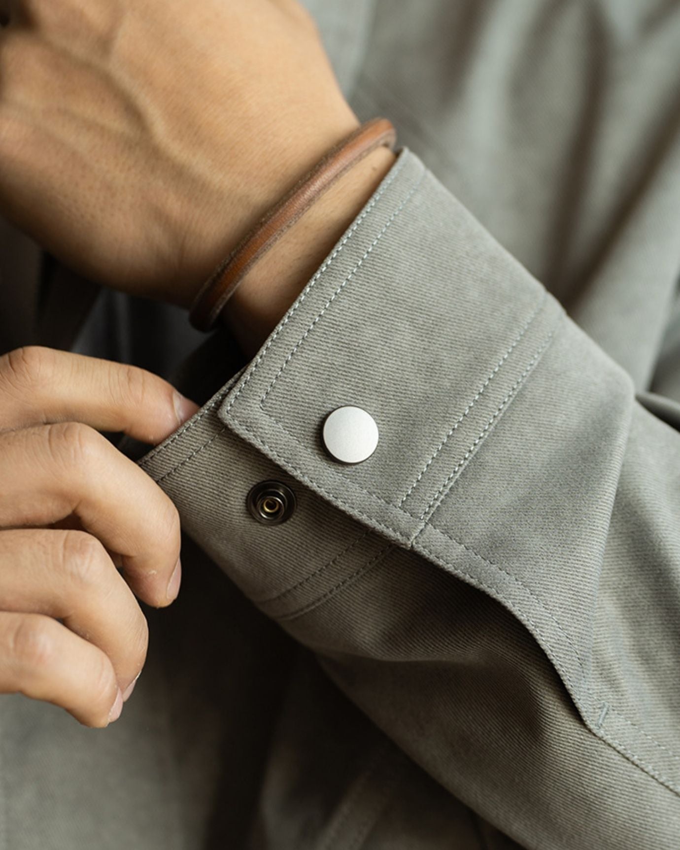Detailed view of Crush Jacket pocket design and button accents