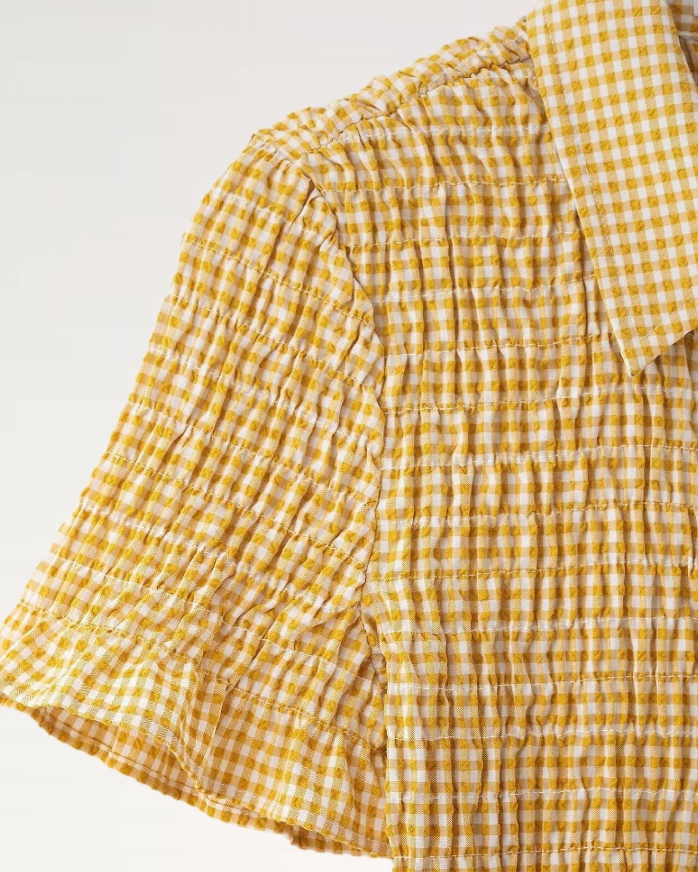 dress featuring fine pleats and vibrant plaid color scheme