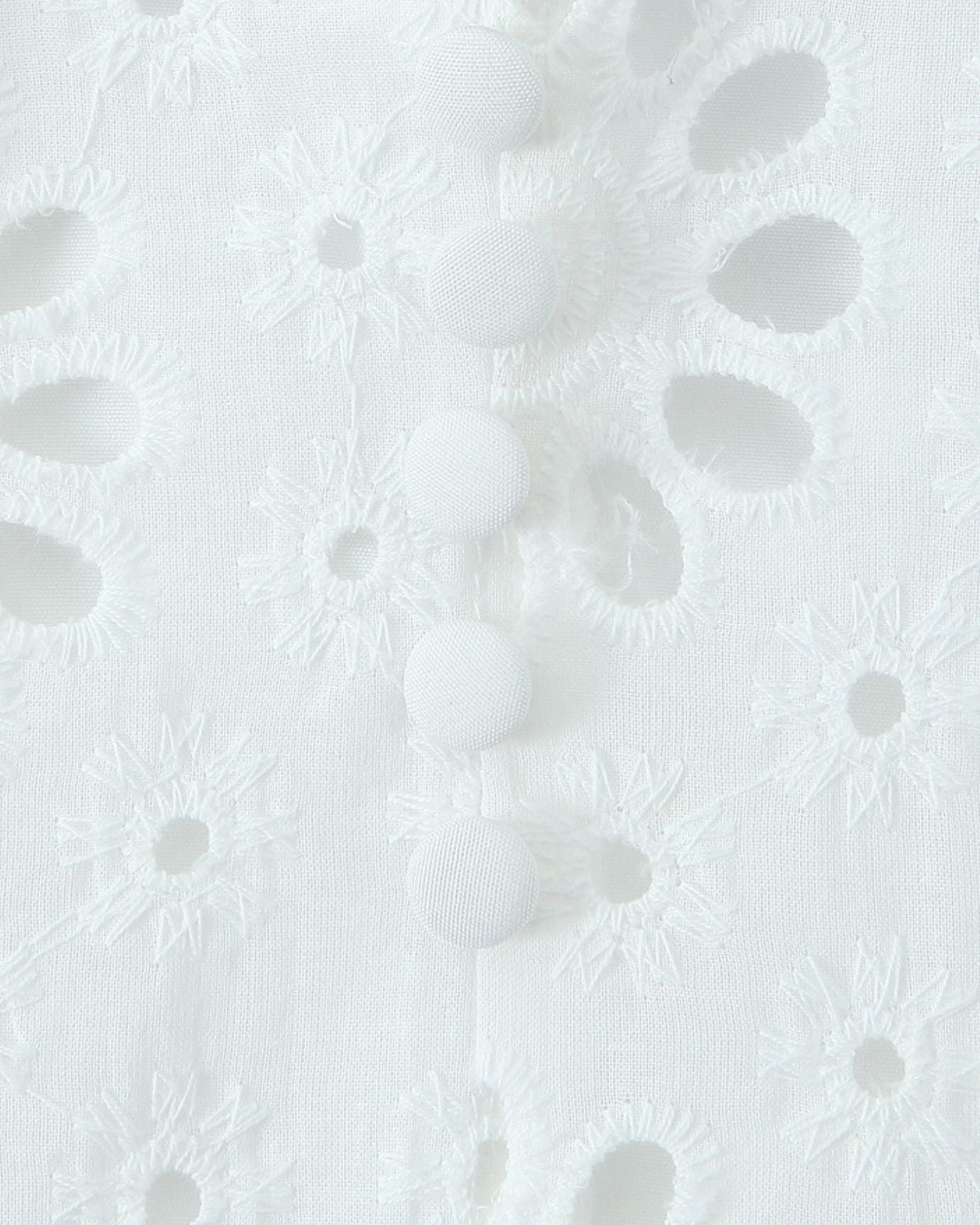 Close-up of delicate lace and embroidery details on Beyond White dress