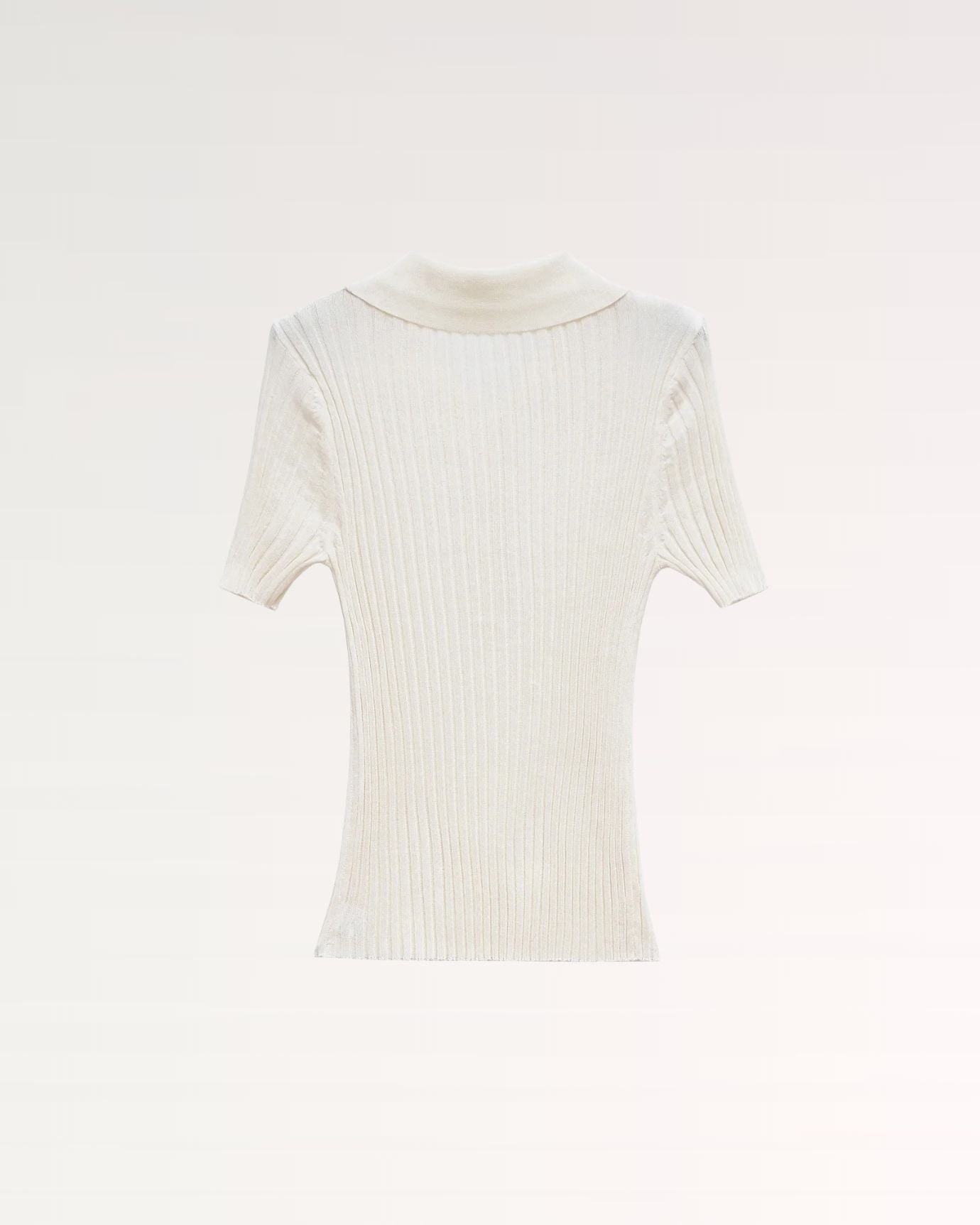 back view showing smooth knit finish and tailored fit of woolen polo