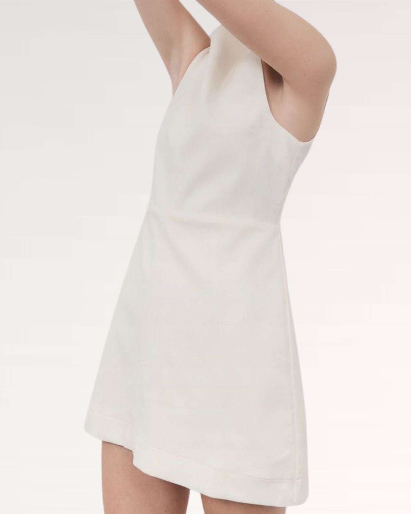 Side profile of white Sofia dress highlighting graceful movement