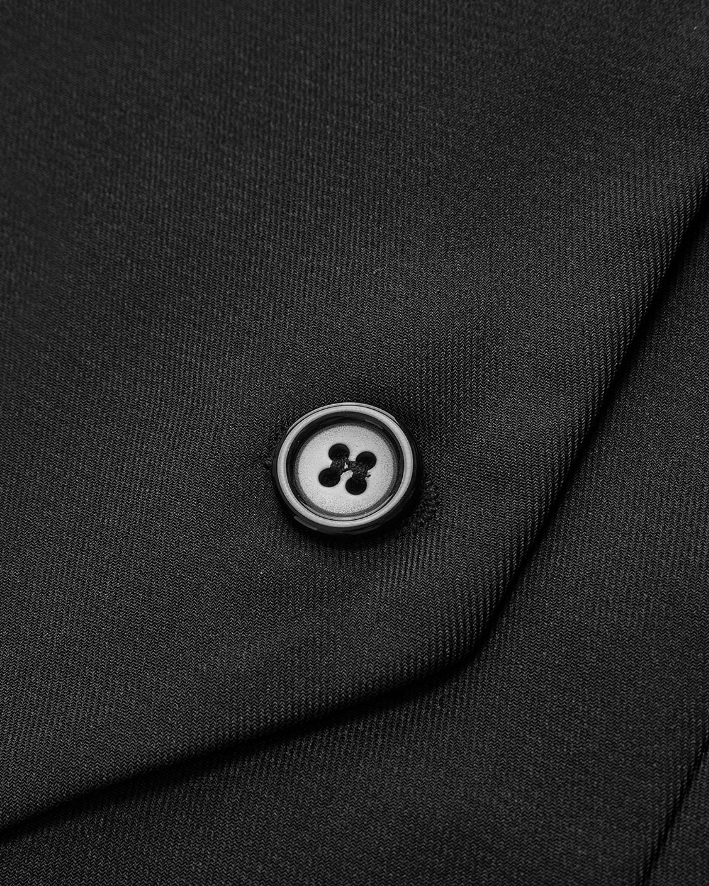 Close-up of the suit waistcoat pleated mini skirt dress set, highlighting the elegant button details on the waistcoat front for a refined finish