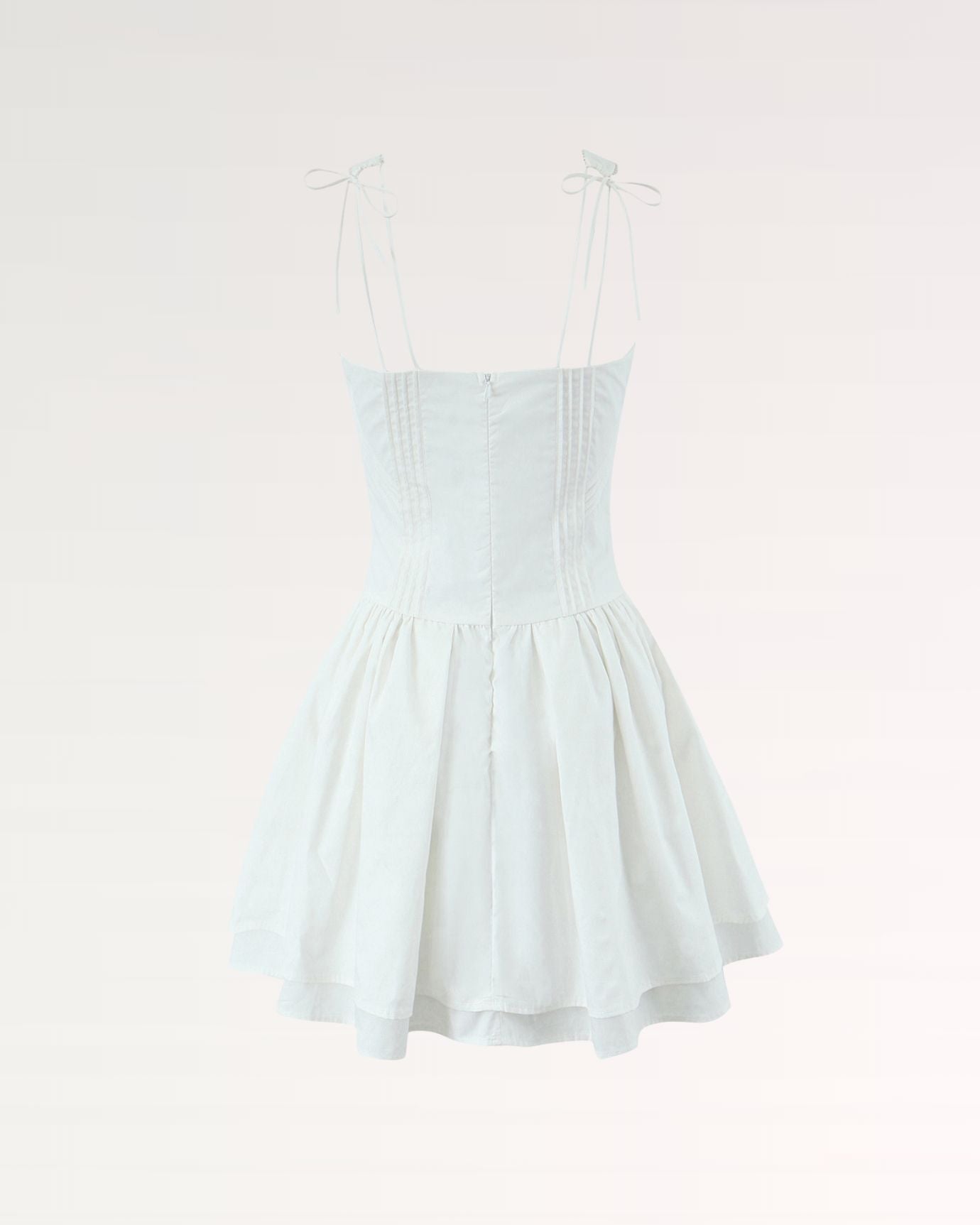 Close-up of soft fabric and straps on White Mini Suspender Dress