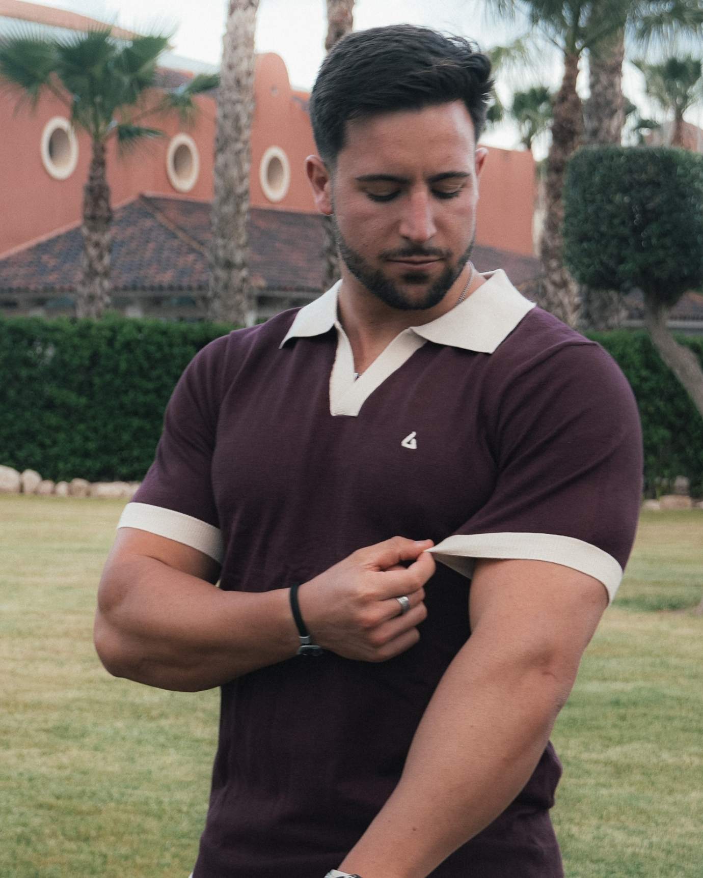 Model wearing tailored Old Money polo shirt in deep Bordeaux color