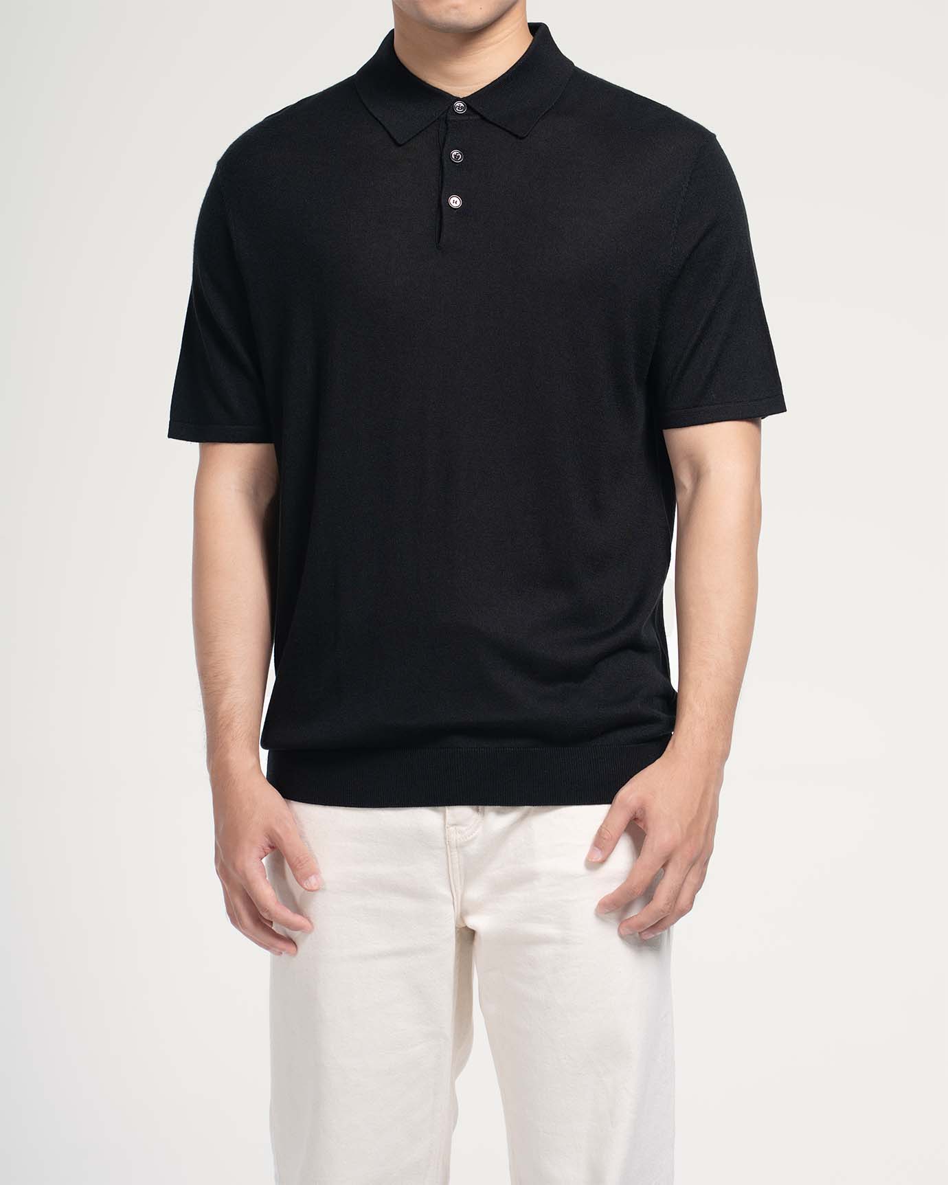 Black silk‑cashmere polo with subtle sheen under light