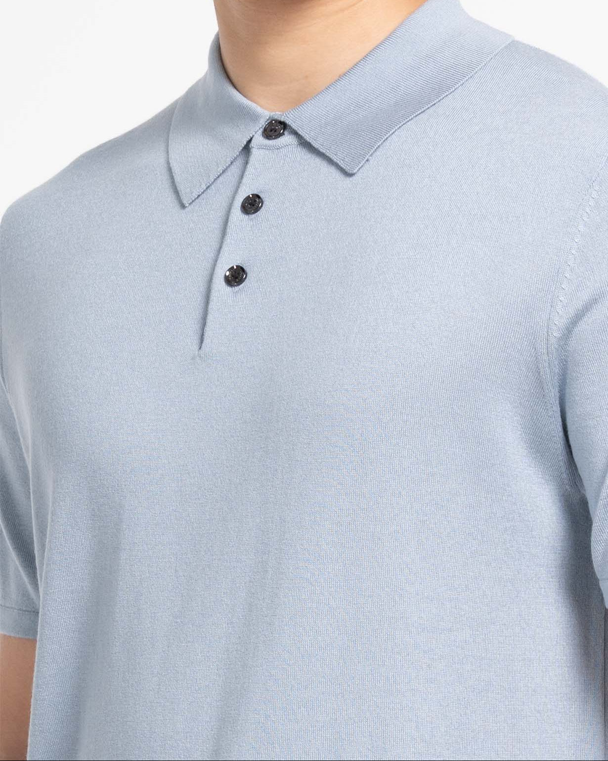 Model wearing cloud blue mulberry silk cashmere short‑sleeve polo