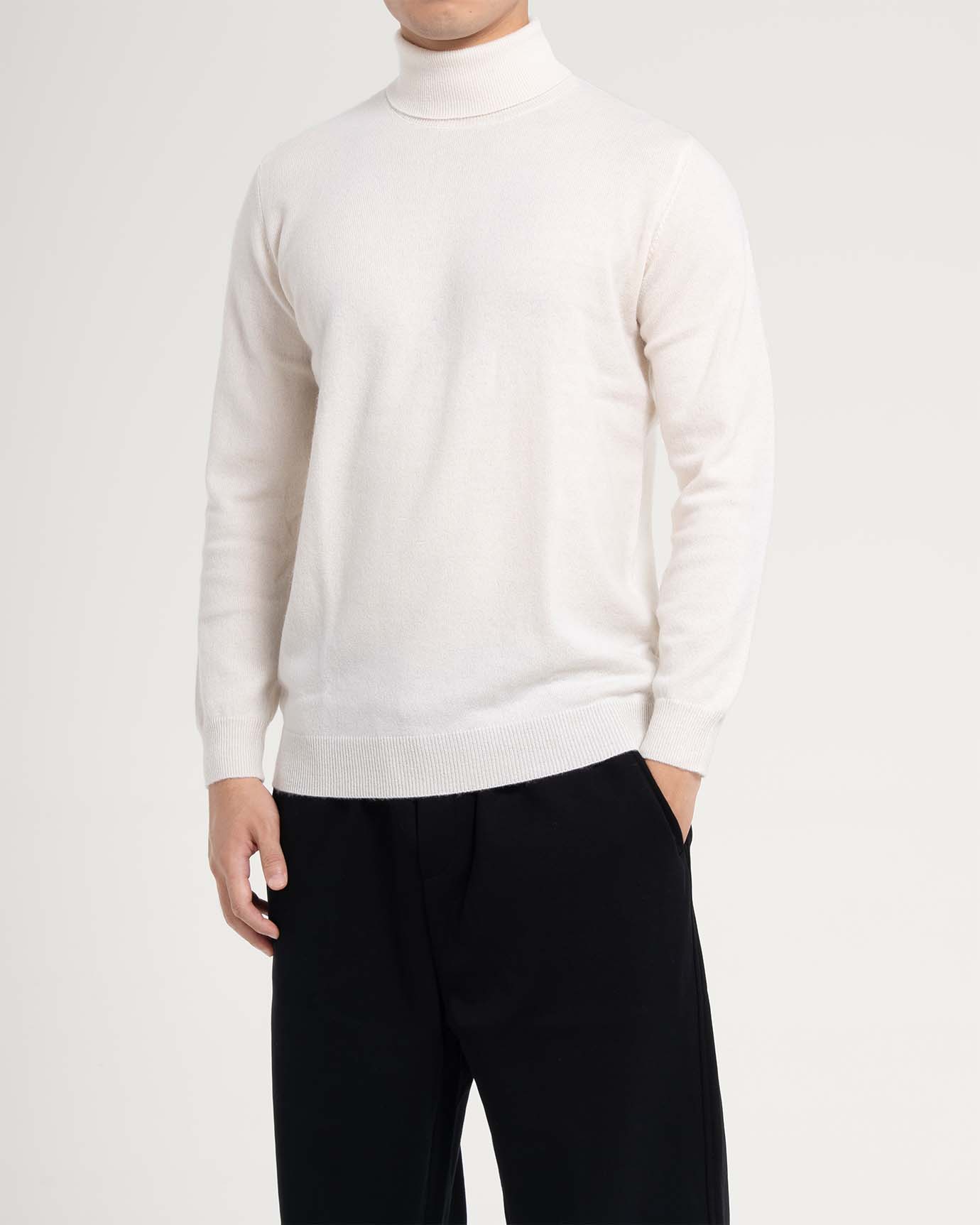 Model in white turtleneck sweater with clean minimal look