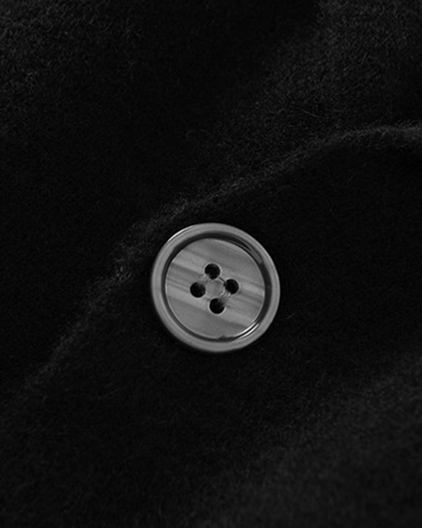 Button and cuff detail of wool cashmere cardigan