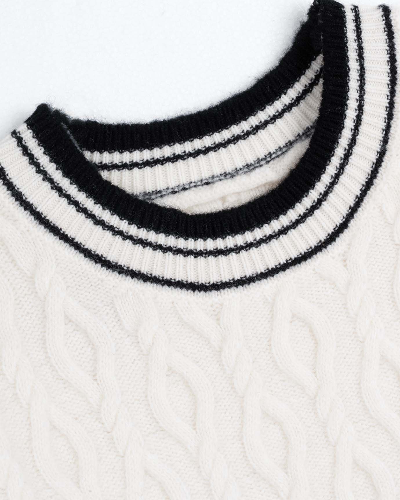 White Old Money sweater draped over wooden hanger