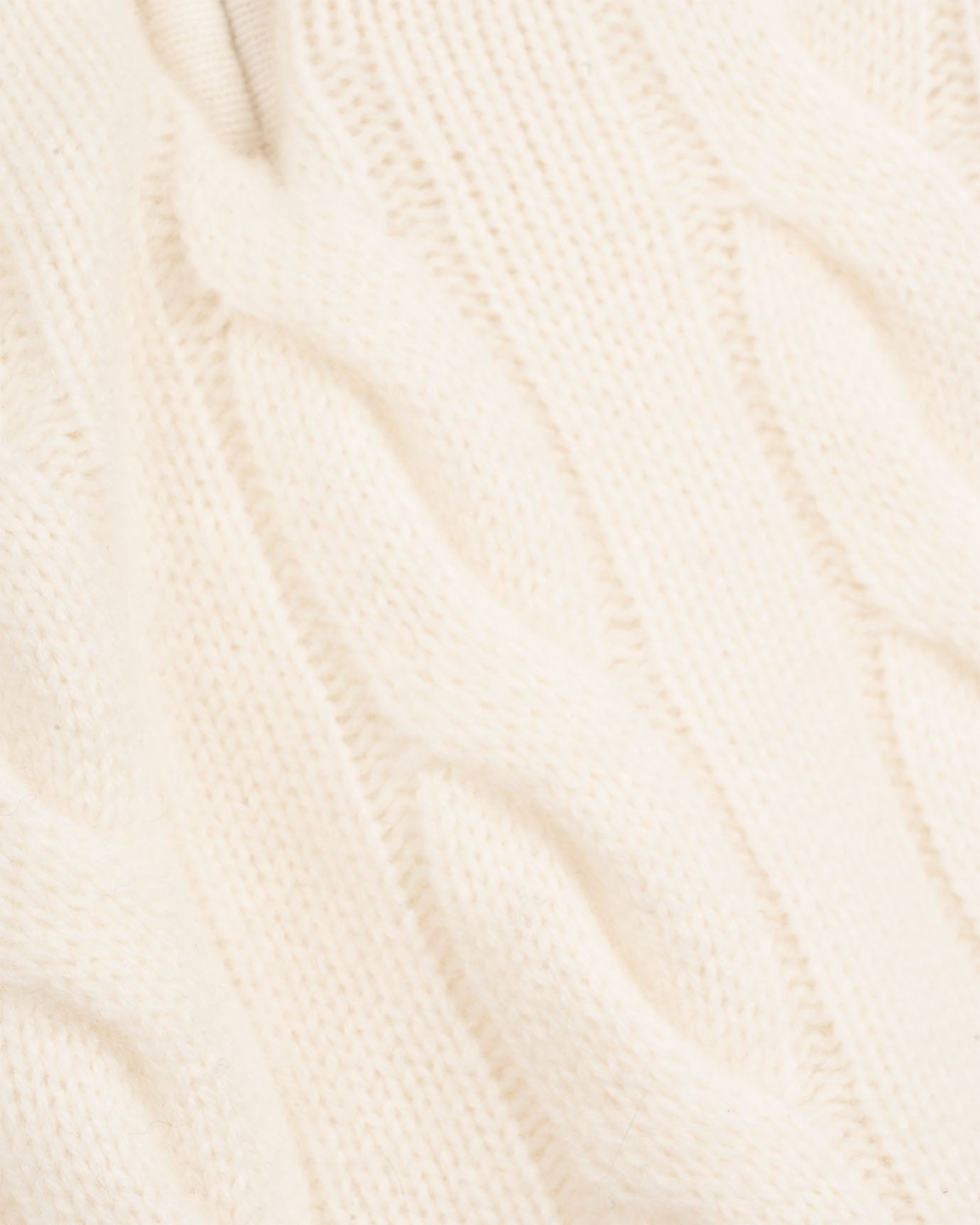 Close-up of beige knitted fabric texture