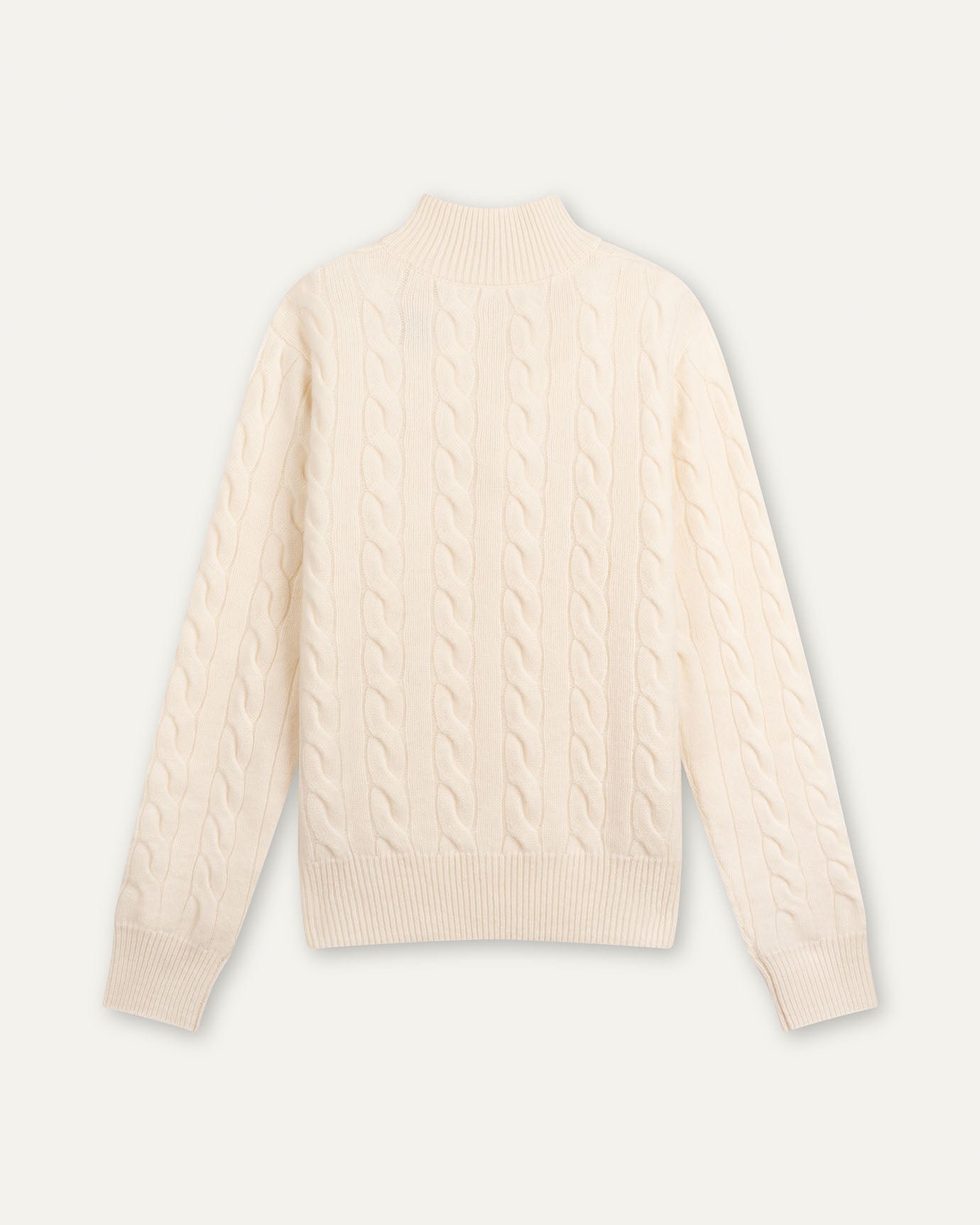 Beige cable knit sweater on a light gray background