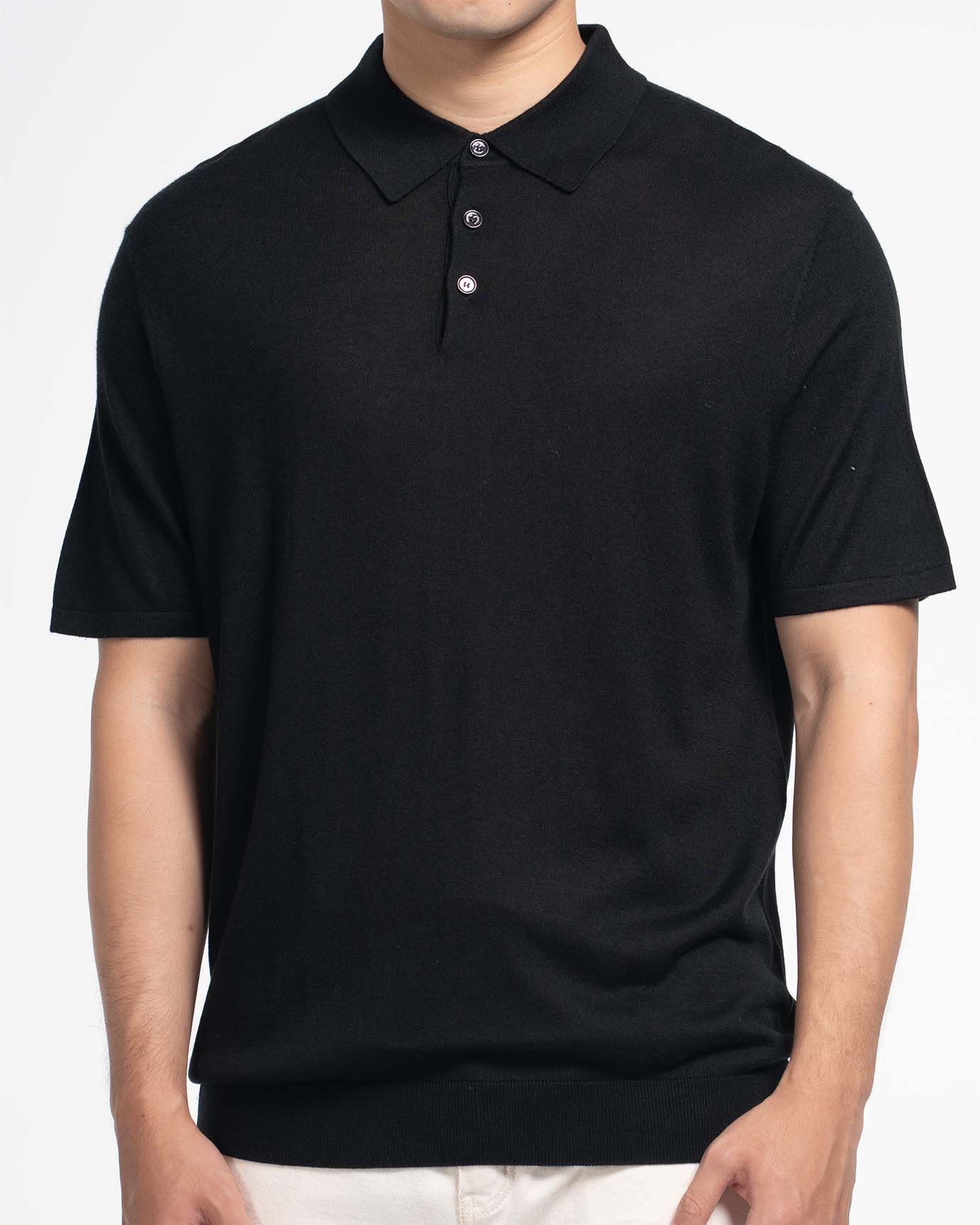 Model wearing black short‑sleeve silk‑cashmere polo