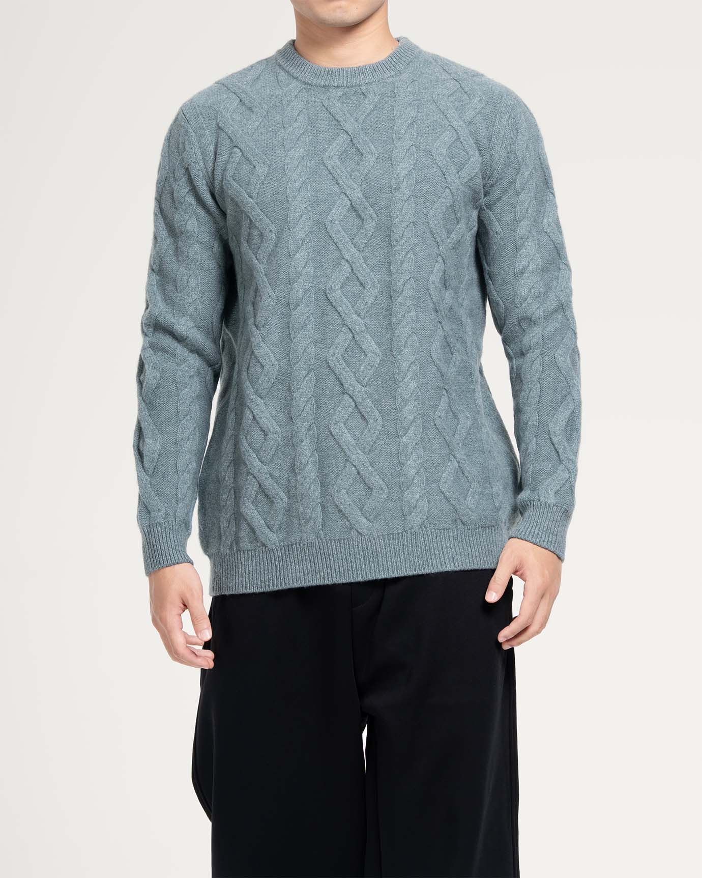 Elegant cold-weather sweater laid flat on white background