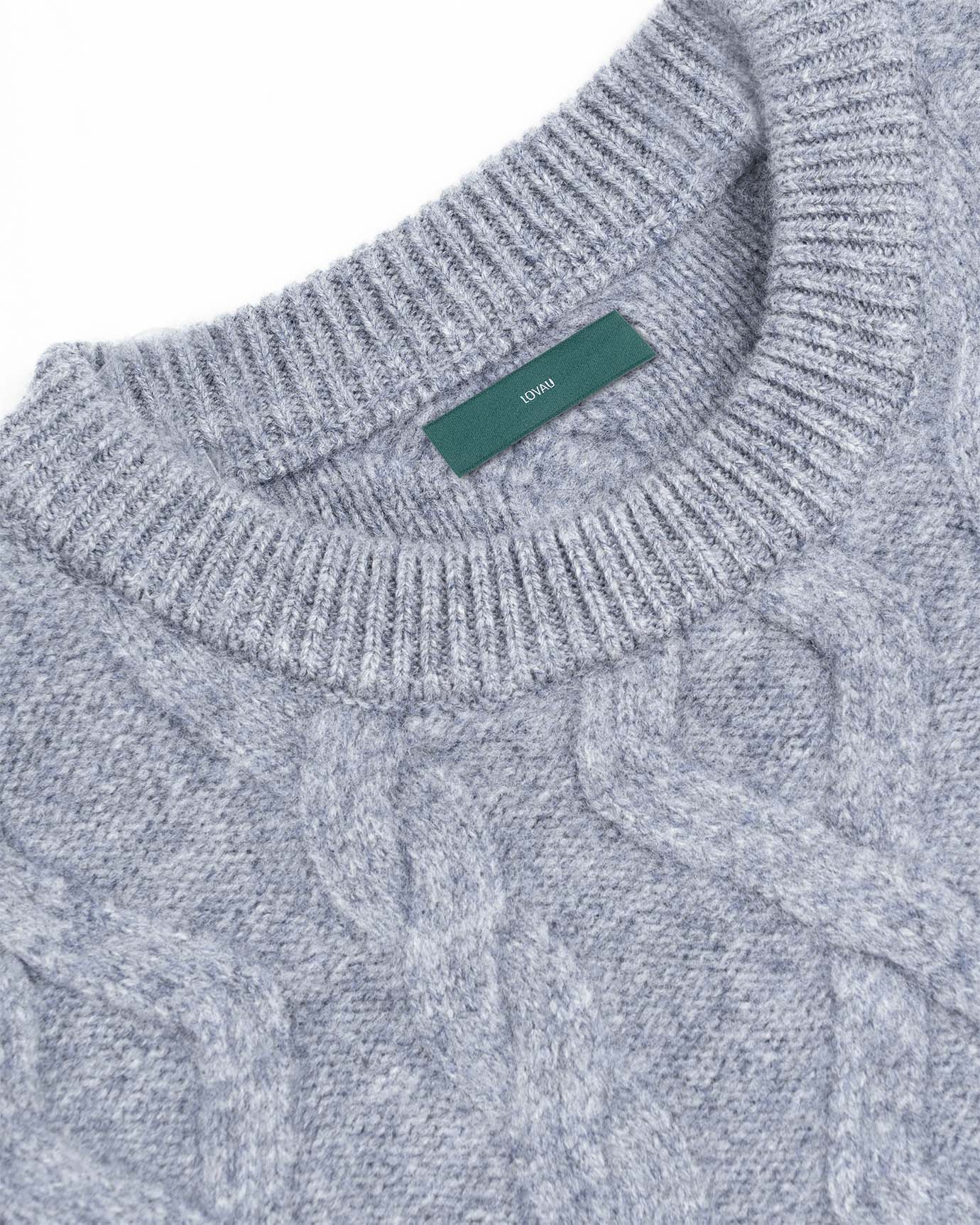 Light grey cashmere blend sweater folded on clean surface